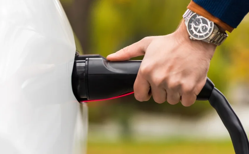 close-view-of-a-man-plugging-charger-into-an-elect-2023-11-27-05-12-52-utc